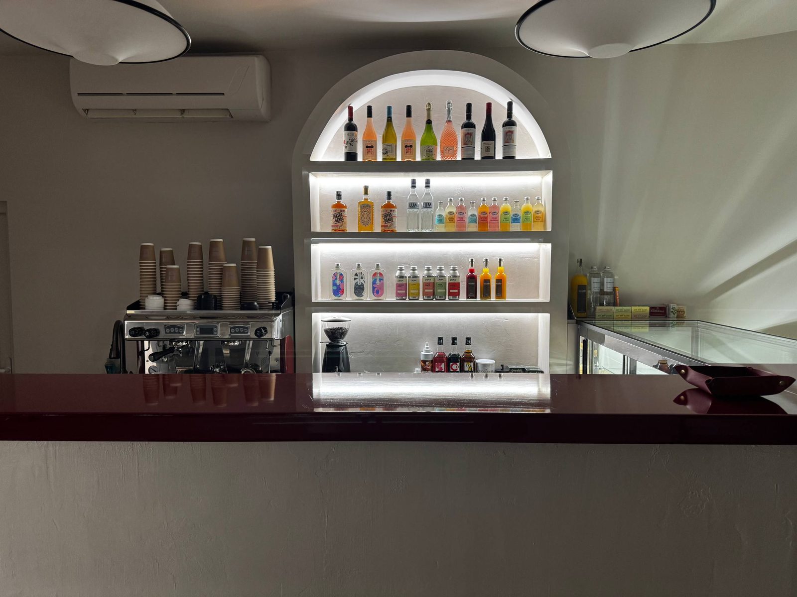 The backlit arched bar with bottles