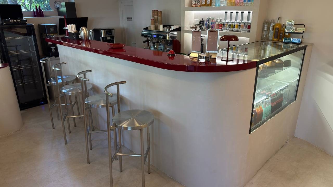 The burgundy counter stretching through the space